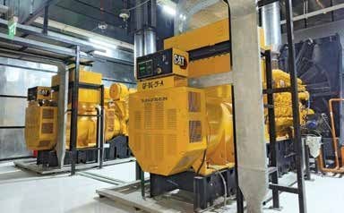 Yellow Caterpillar generator sets installed inside a data-centre power facility