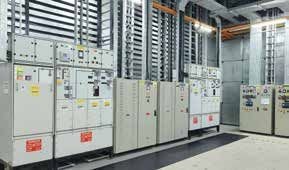 Rows of electrical switchgear cabinets inside a data-centre power room